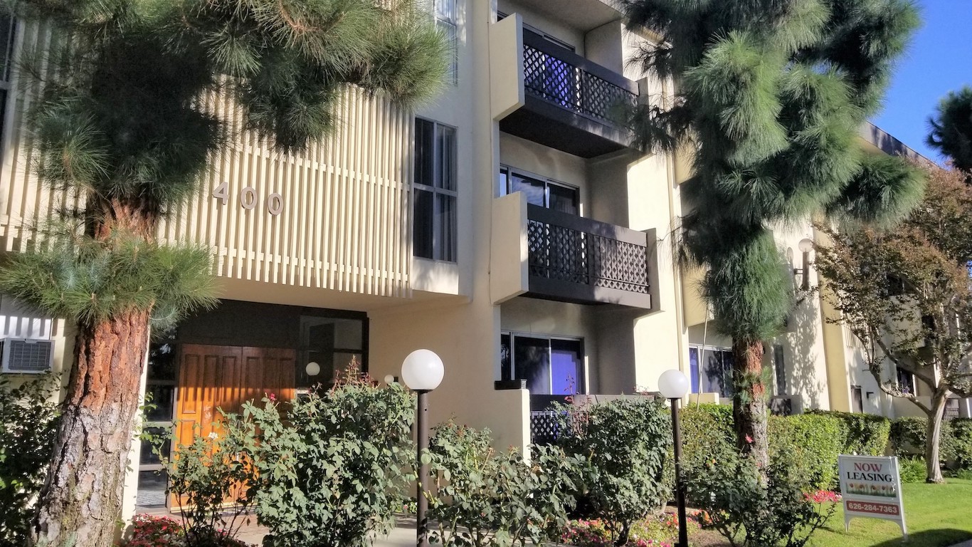 The exterior of the apartment complex, landscaped entrance